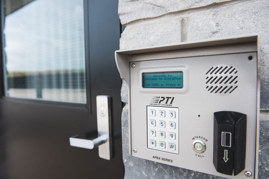 A black door with a secure UltraStor lock beside it, featuring key card access, code access and a speaker for added security.