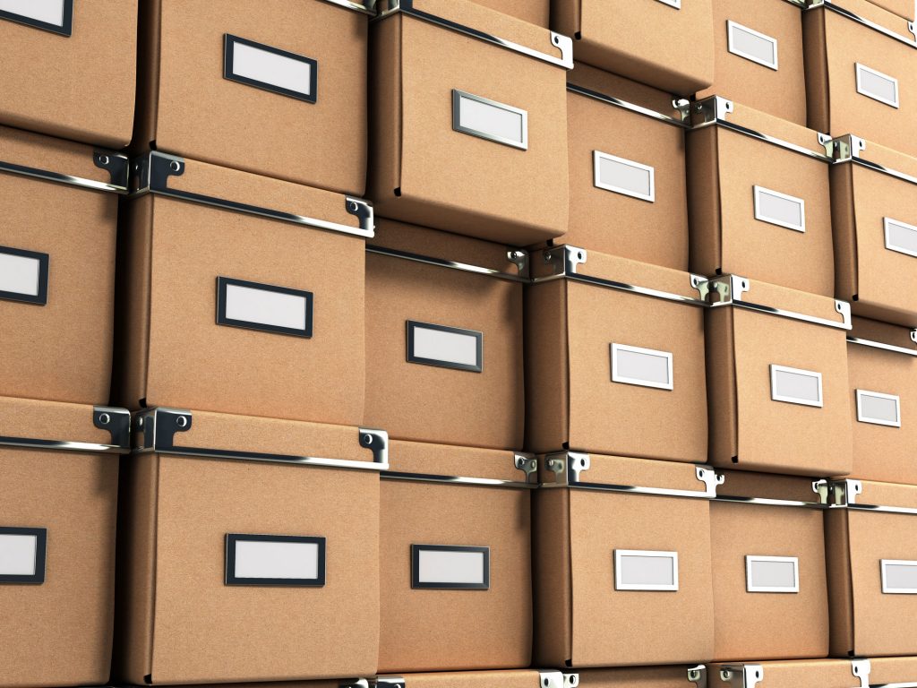 Wall of storage boxes with lids and labels.